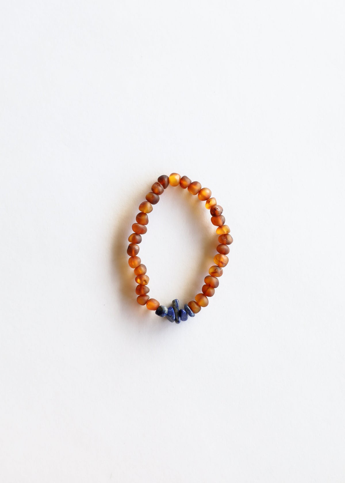 Cognac amber and lapis lazuli beaded bracelet with orange beads and blue stone accent