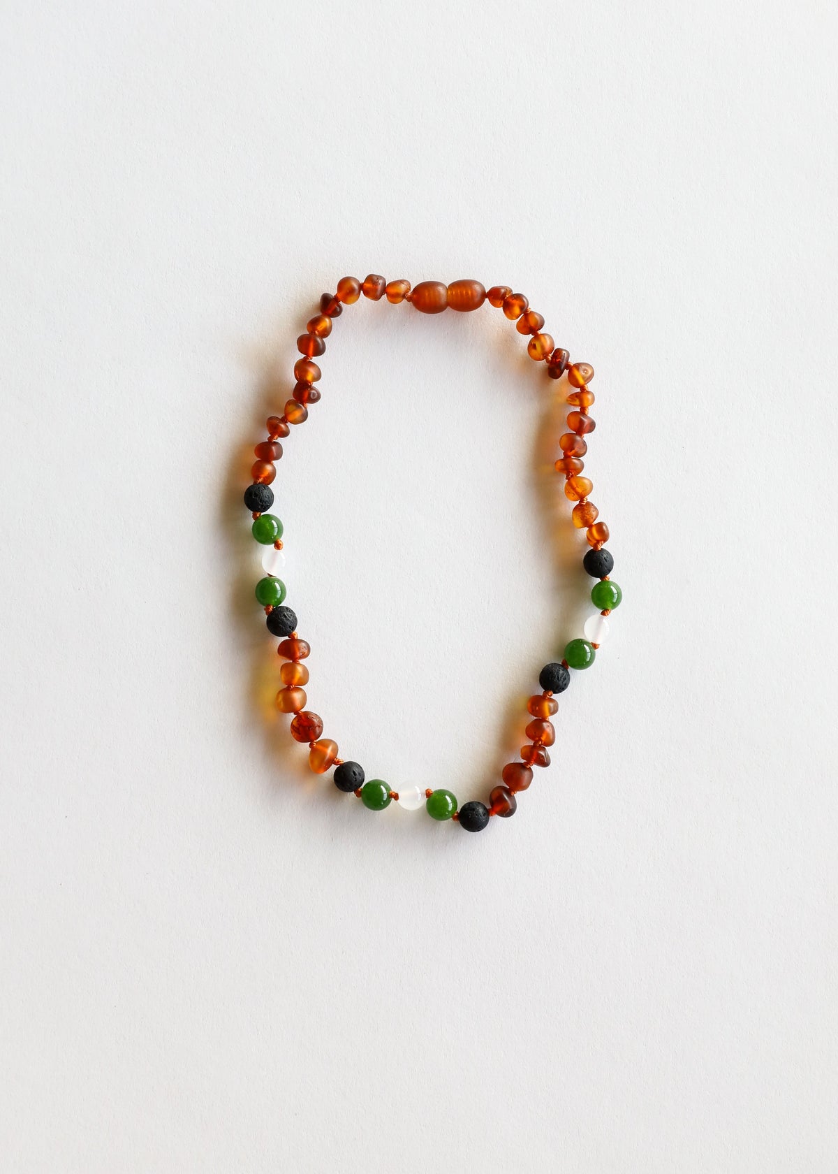 Beaded necklace with cognac amber orange, green and dark stone beads