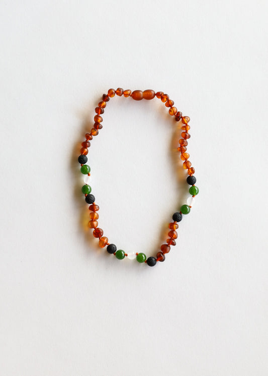 Beaded necklace with cognac amber orange, green and dark stone beads