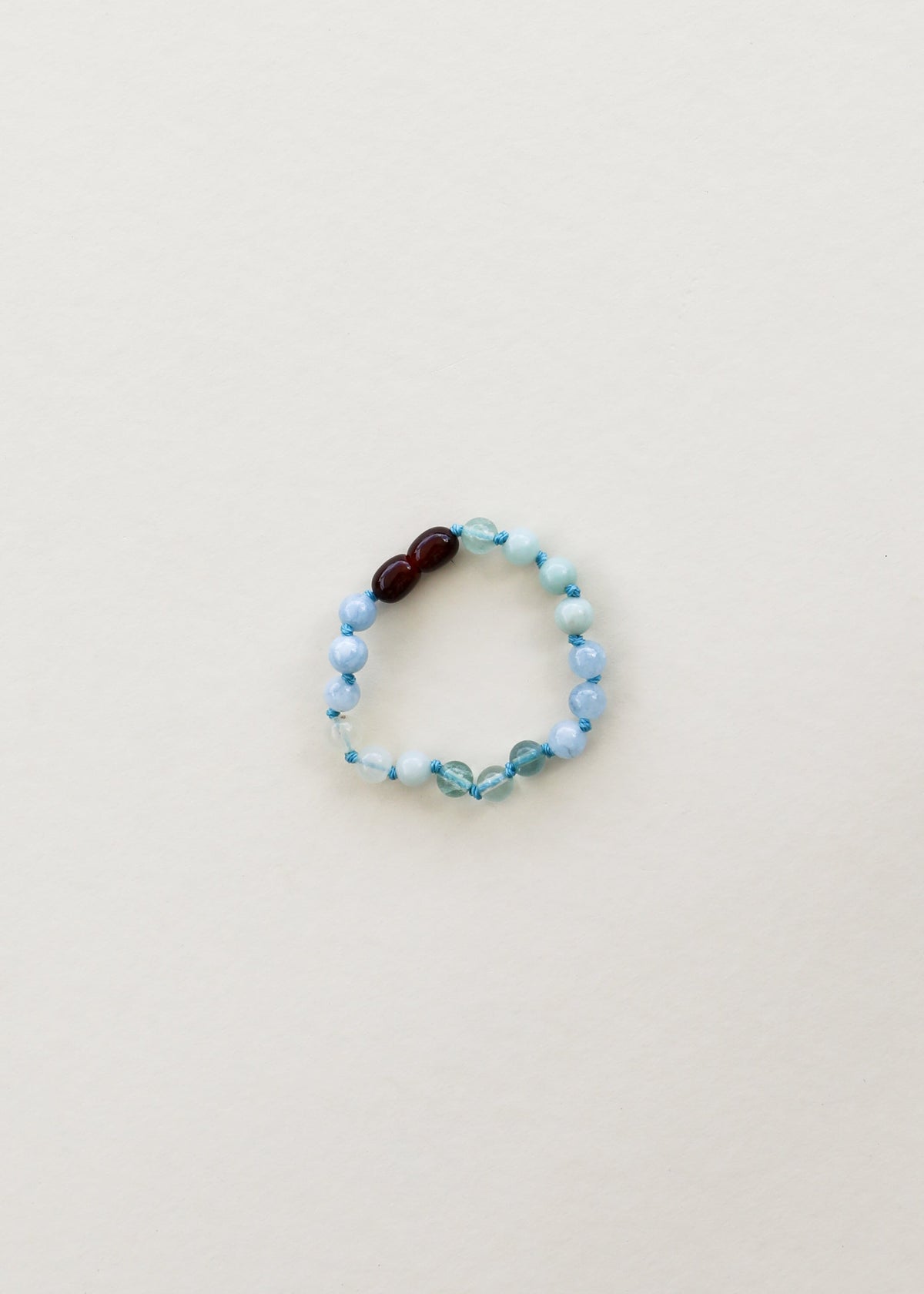 Light blue gemstone beaded bracelet with dark brown accent beads