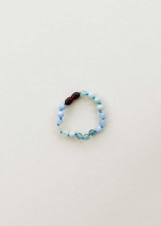 Light blue gemstone beaded bracelet with dark brown accent beads