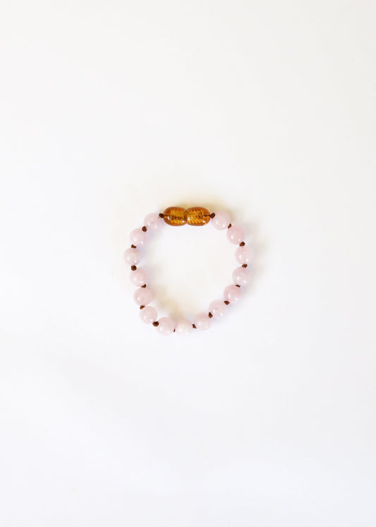Rose quartz bead bracelet with gold-tone clasp bead center