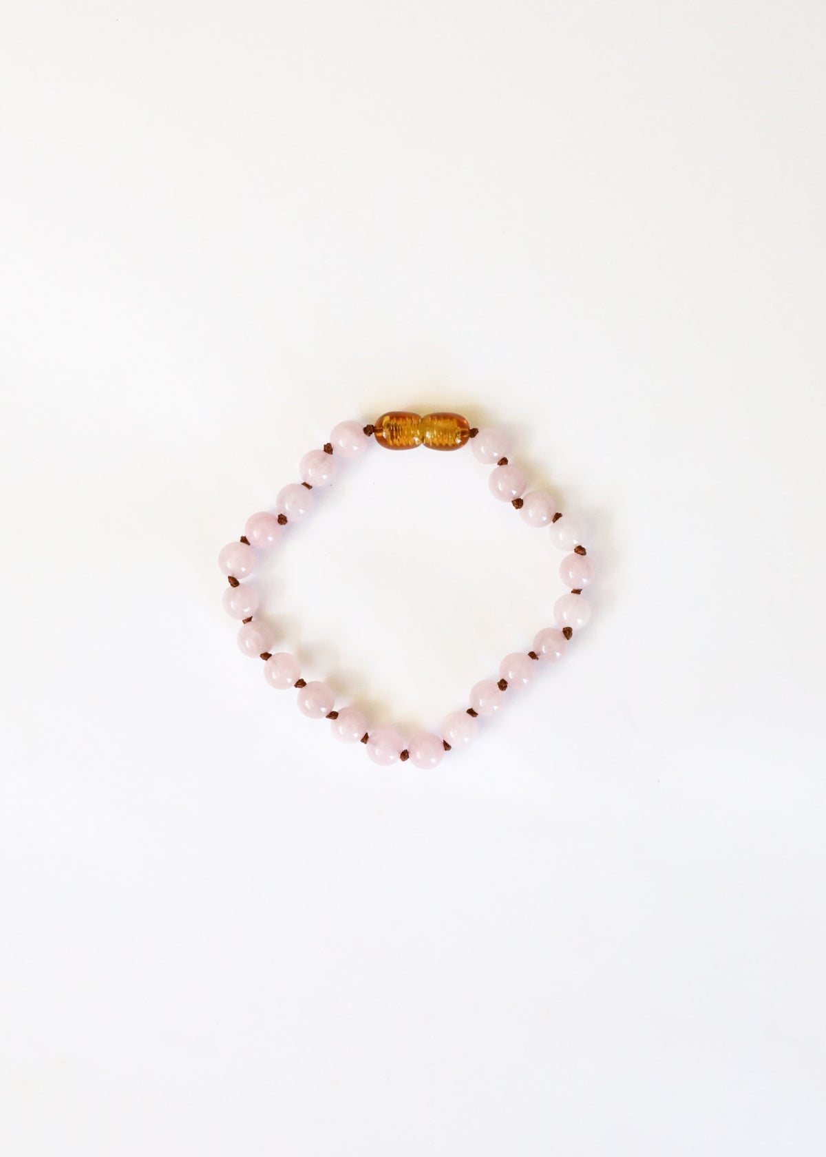 Rose quartz bead bracelet with gold-tone clasp bead across top