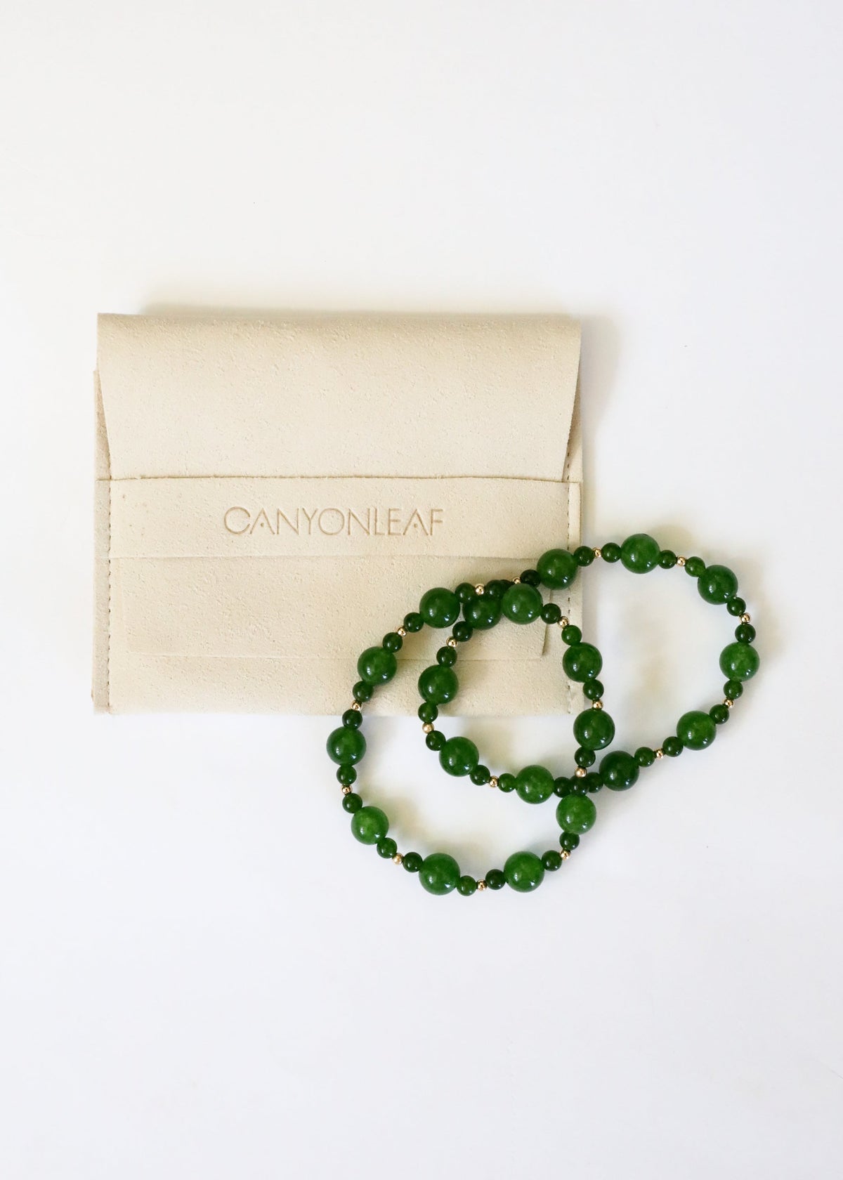 Green jade beaded stretch bracelet with box, angled coil