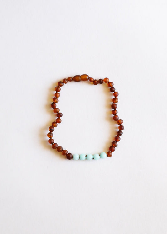 Cognac amber bead necklace with turquoise amazonite accent cluster at center bottom