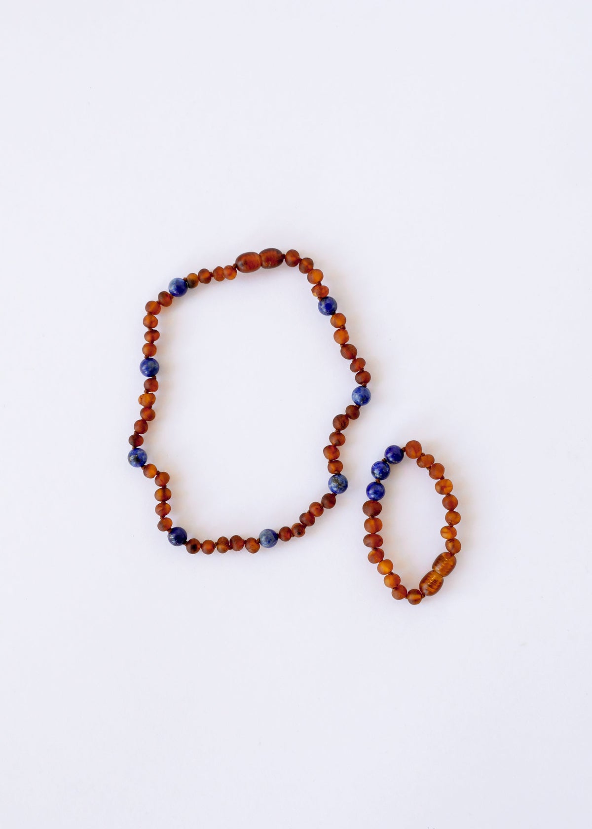 Amber and lapis lazuli bead halo necklace, two oval loops with orange-brown and blue beads