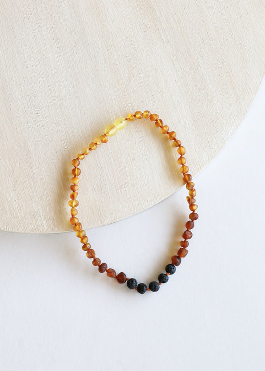 Amber and lava bead necklace with ombre warm yellow to amber and black accents