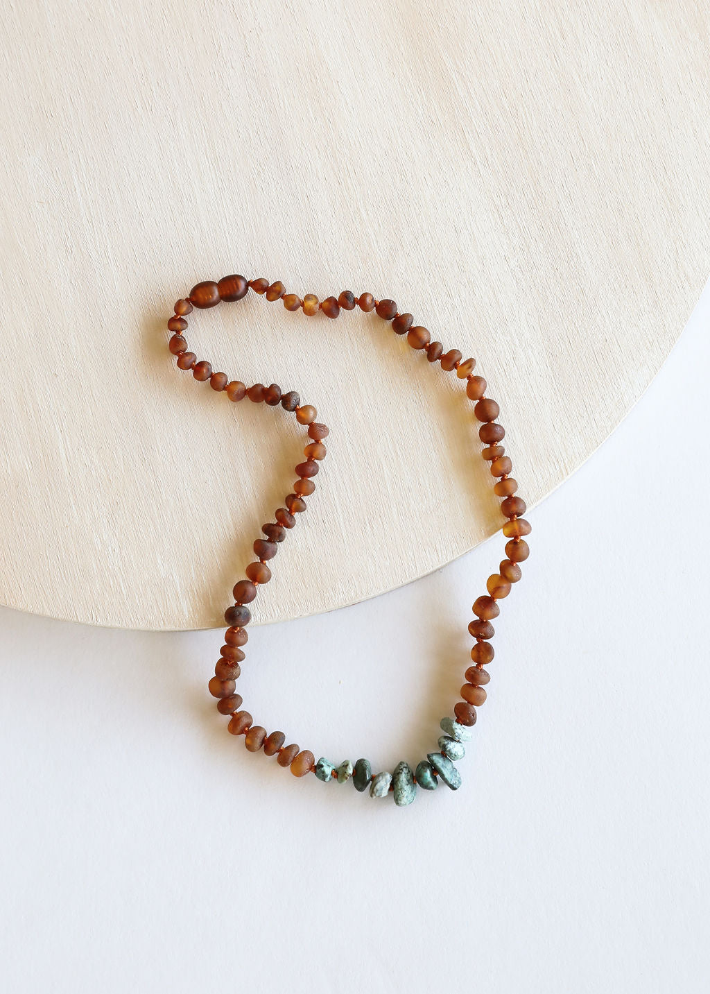 Cognac amber bead necklace with raw turquoise jasper teardrop stones, coiled