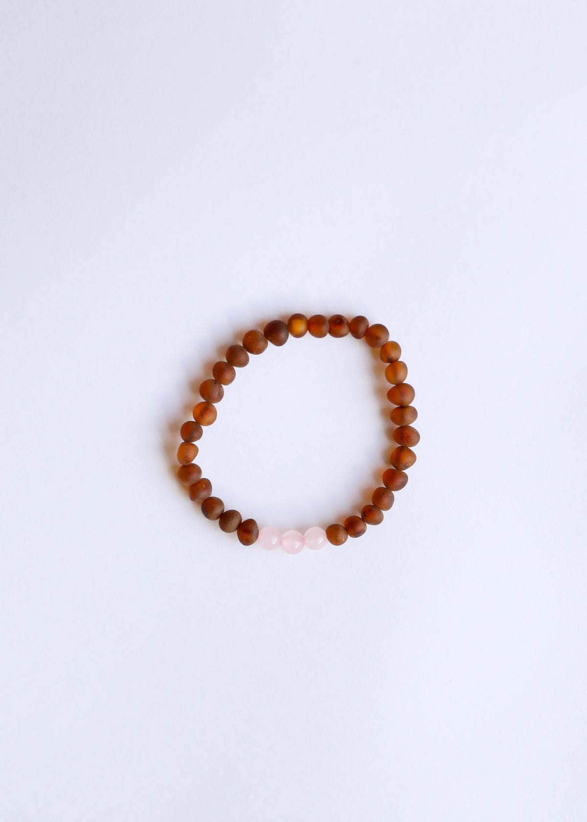 Brown amber and pale white bead bracelet with round elastic band