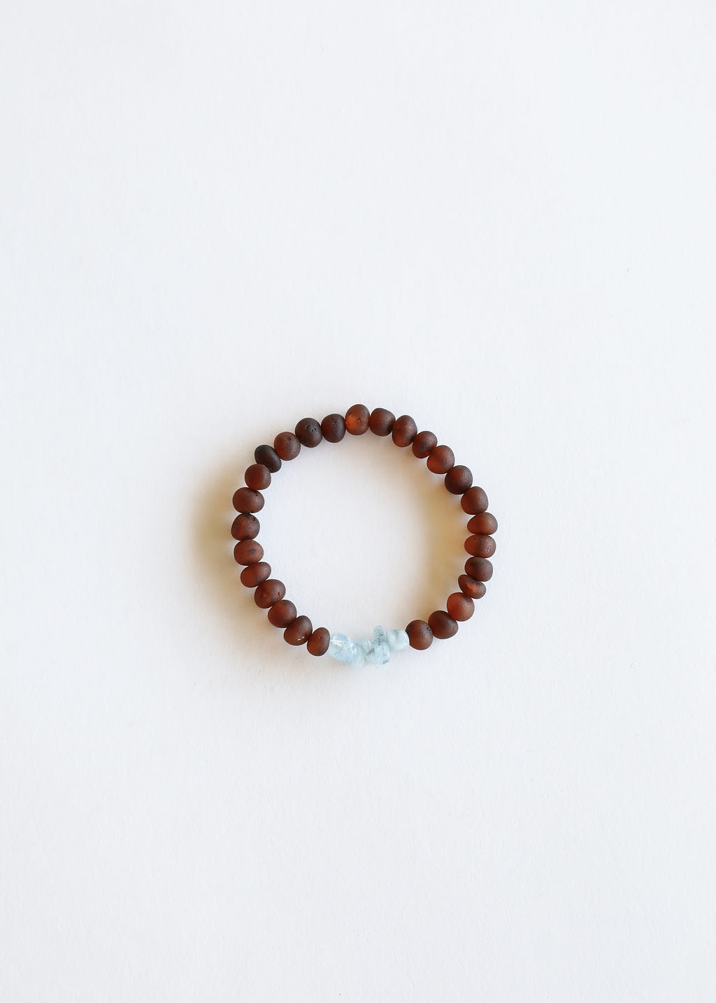 Adult bracelet with dark brown amber beads and raw light blue stone