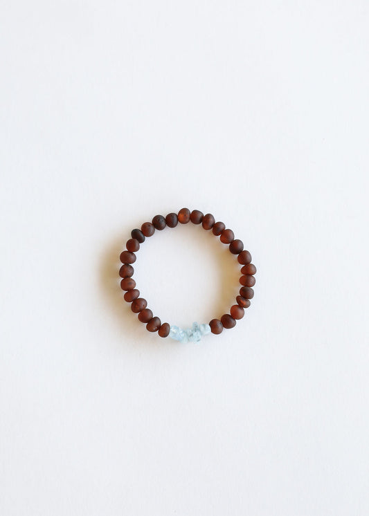 Adult bracelet with dark brown amber beads and raw light blue stone