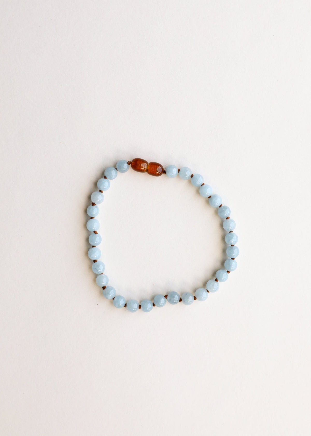 Aquamarine bead bracelet loop with amber center bead accents