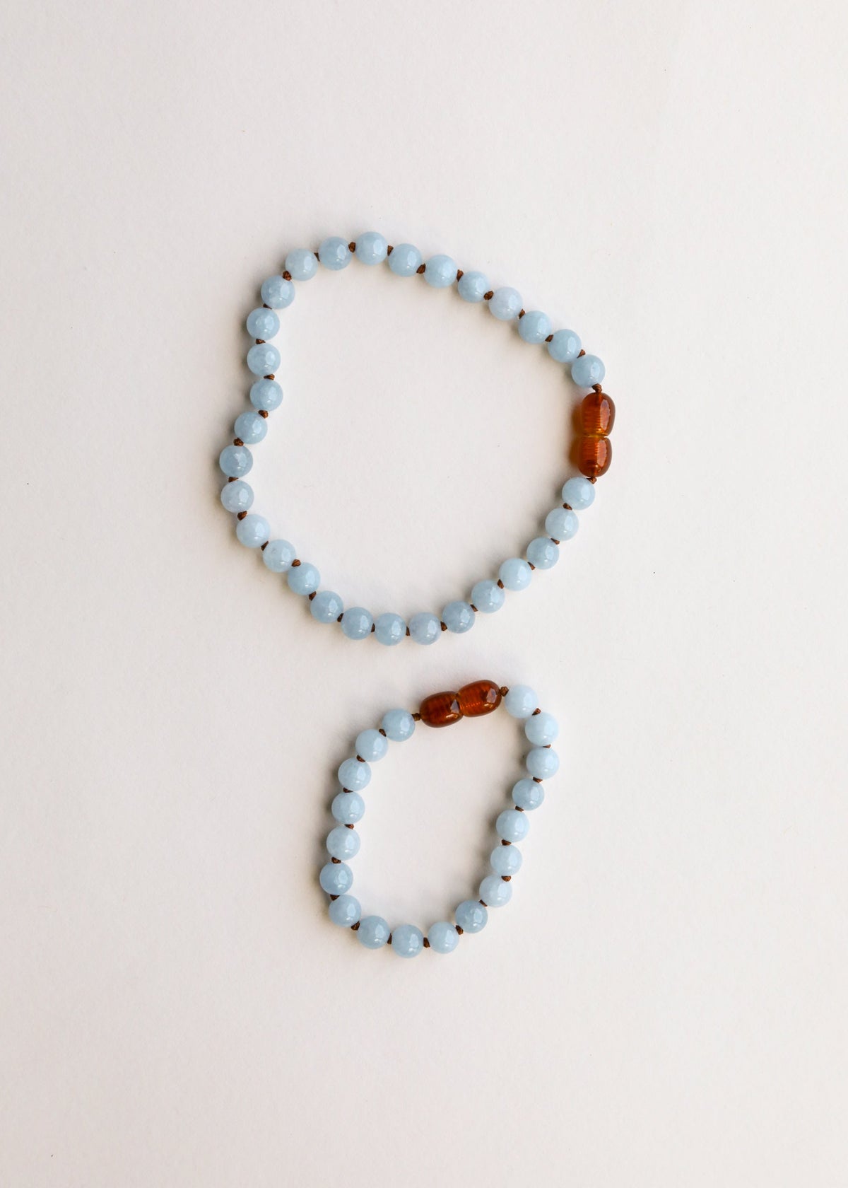 Aquamarine bead bracelet and anklet set, each with amber bead on the edge