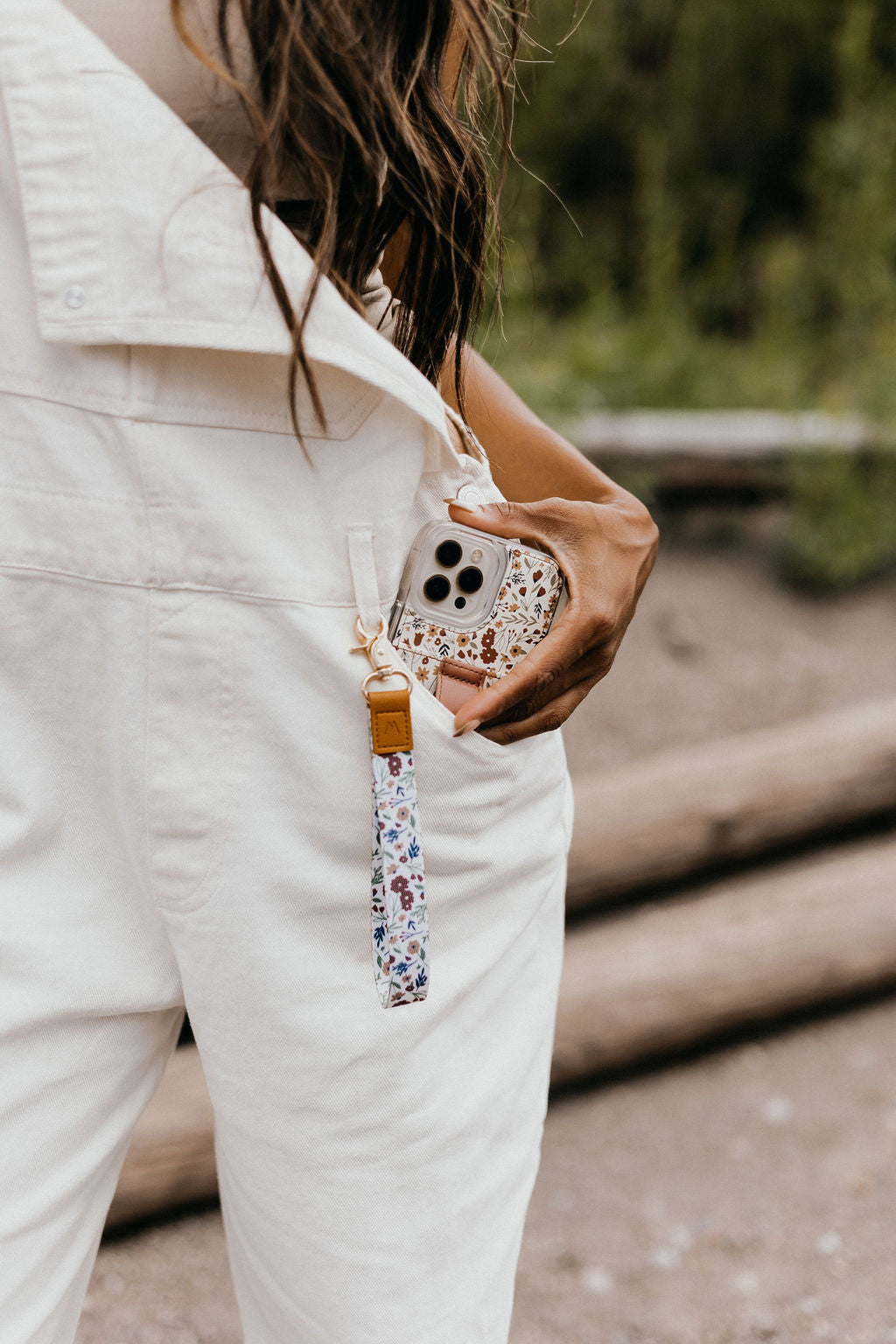 Floral wrist strap with tan leather connector and metal keyring
