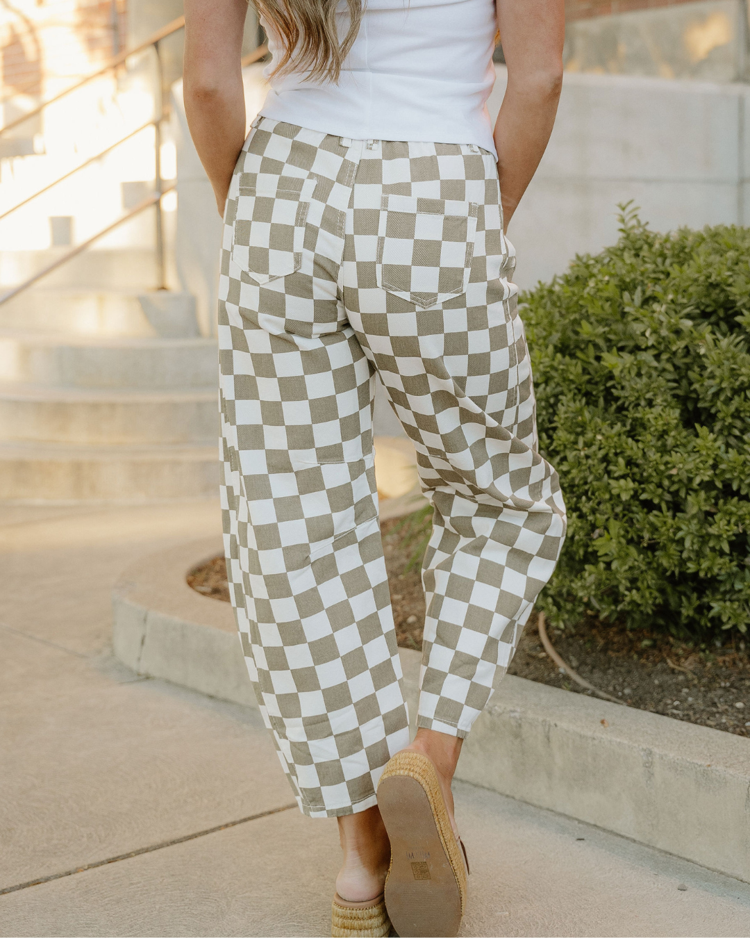 Close-up: sage green and off-white checkered denim barrel pants with front patch pockets