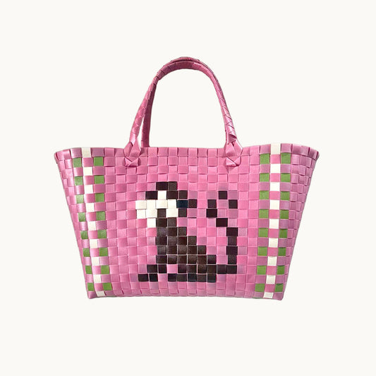 Pink woven basket bag with green check border and pixel-style monkey face front panel