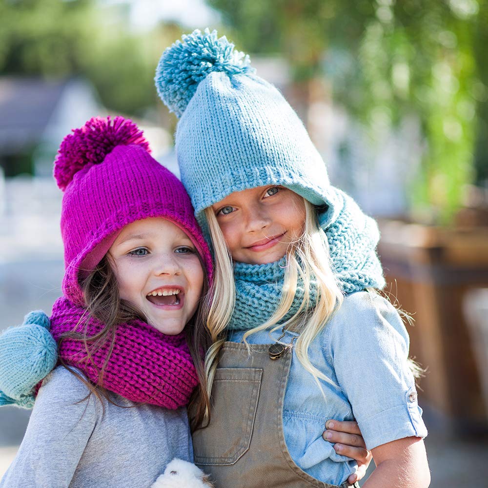 Children wearing berry pink and light blue knitted earflap hats