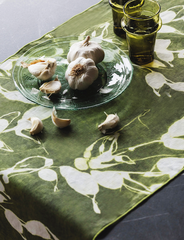 Olive green table runner with white botanical print, glass bowl centerpiece