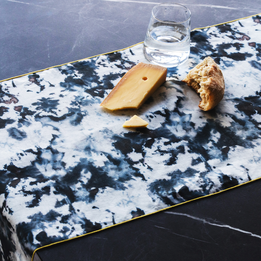 Grey marble-pattern runner with gold border trim, corner and edge detail