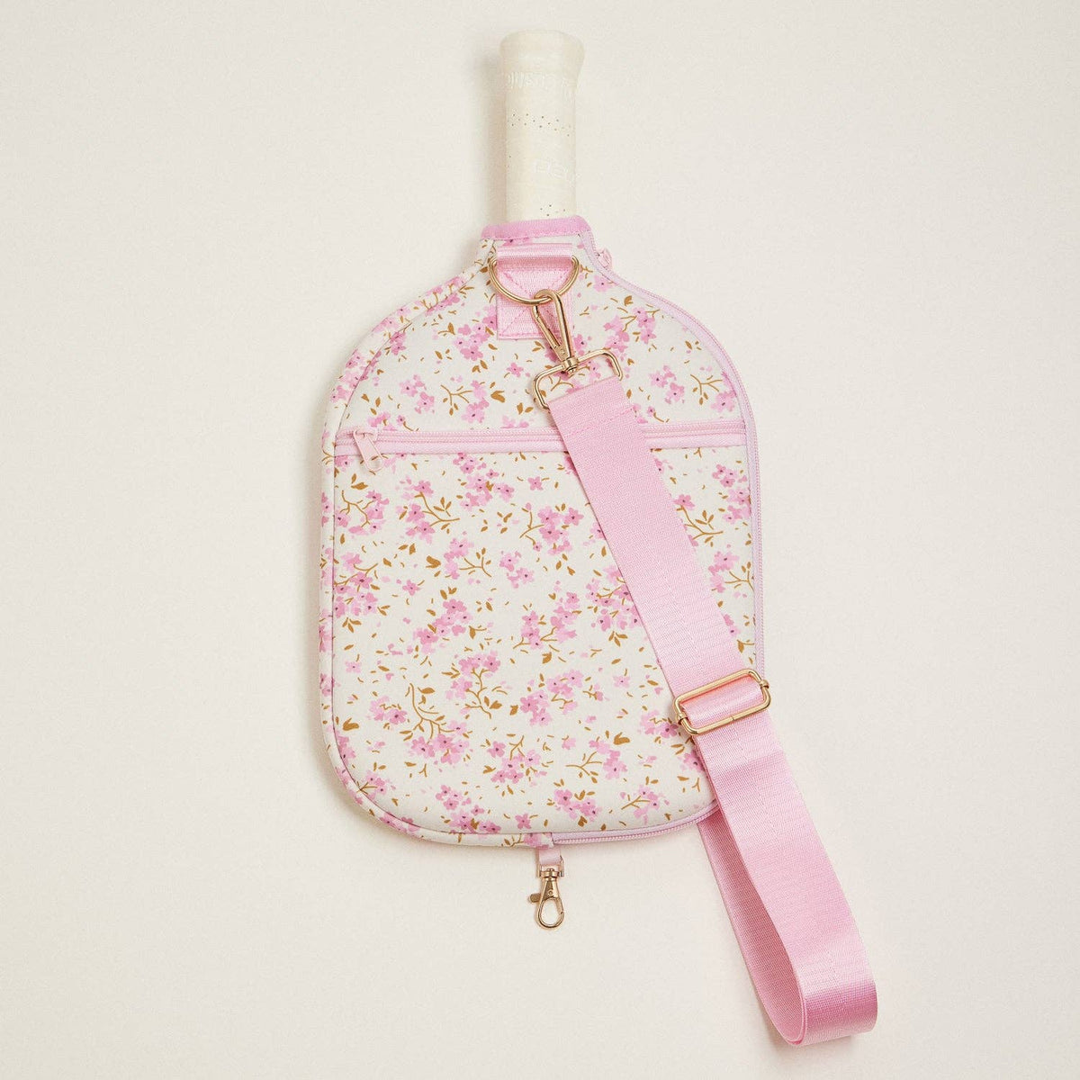 Floral neoprene pickleball paddle bag with pink adjustable strap and front zip pocket