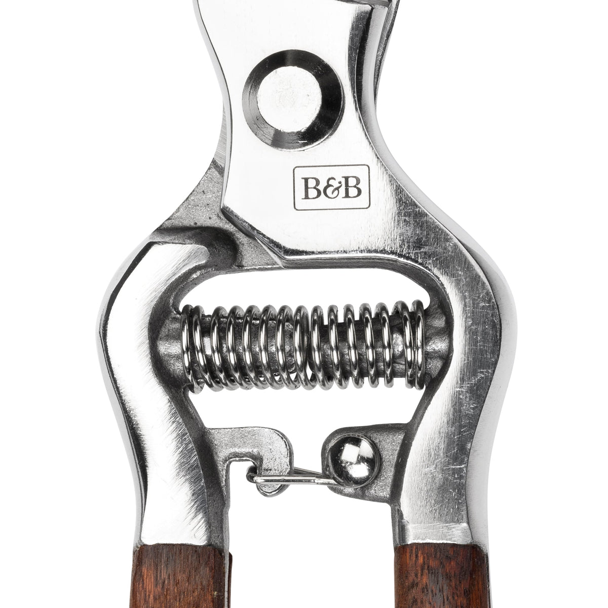 Bypass pruner head close-up with spring, screw pivot, and B&B logo