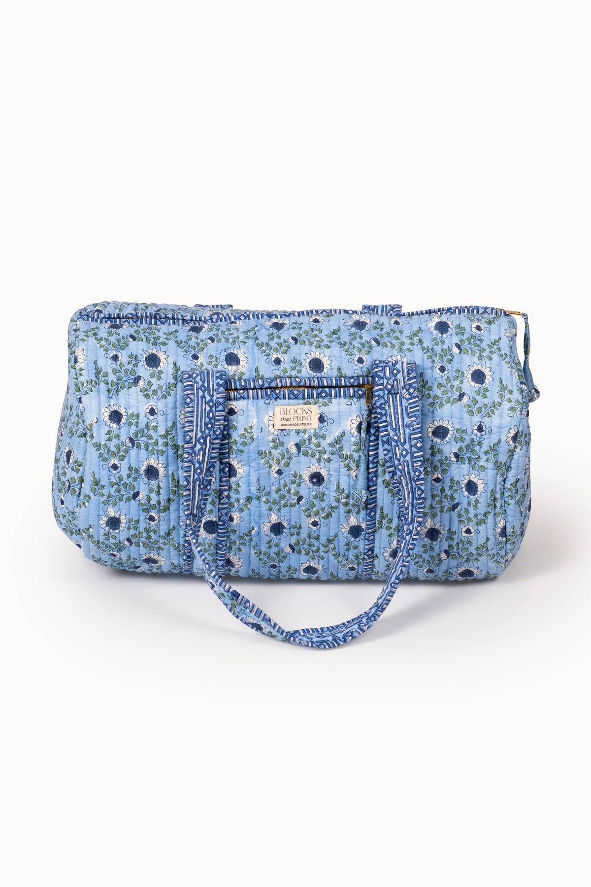 Quilted ocean-blue block print duffle bag with top zipper and stitched handles