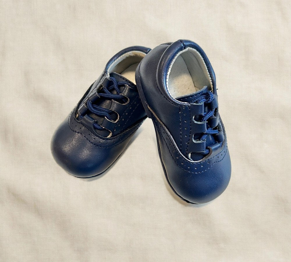 Kids lace-up dress shoes with wide toe box, dark navy leather, angled pair view