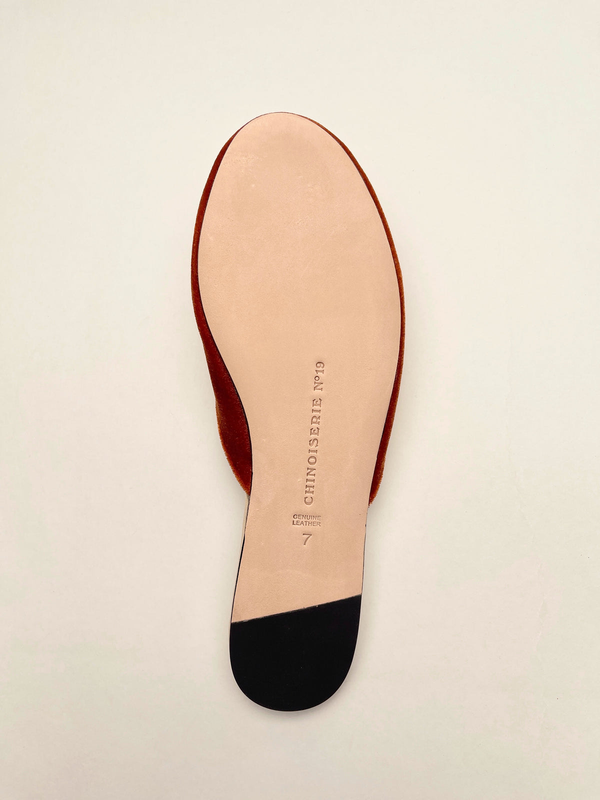Burnt orange velvet mule with brand text on insole, bottom view