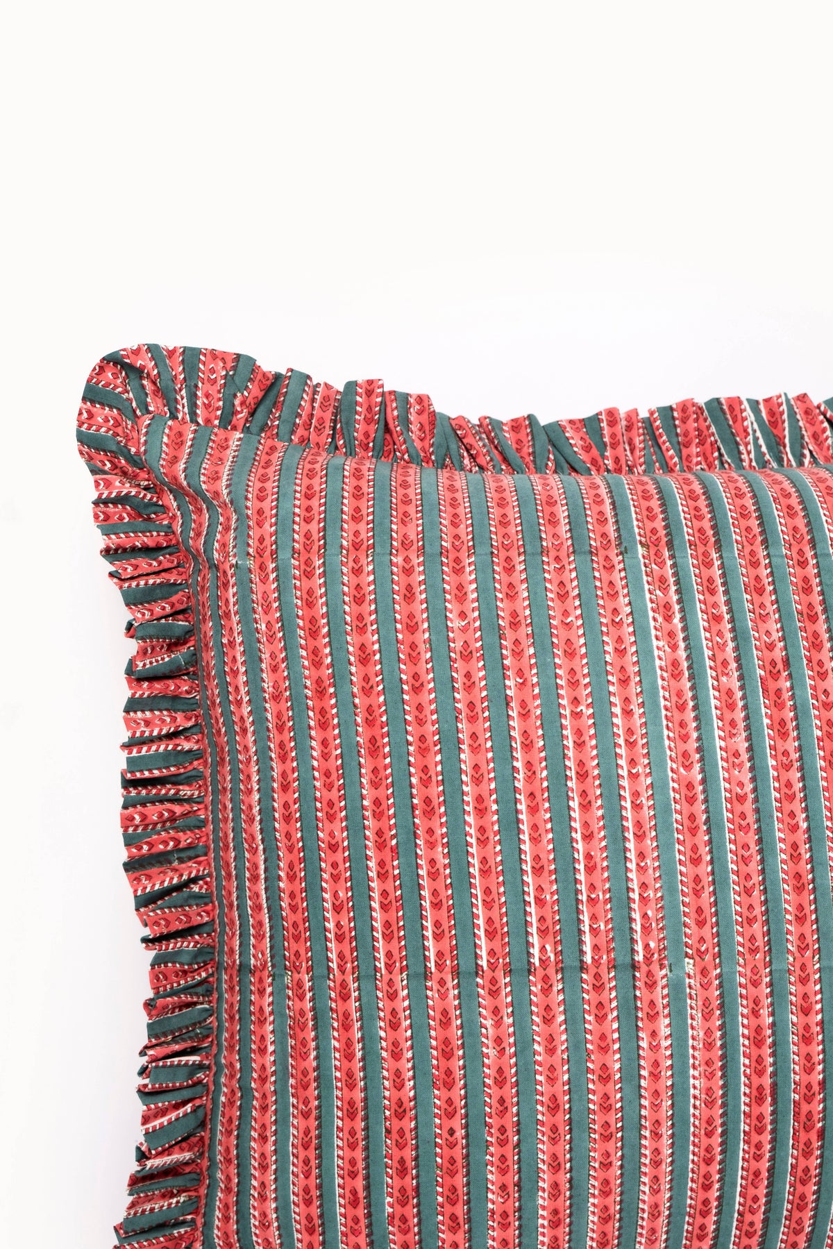 Close-up of crimson blockprint ruffle-edge pillow cover with vertical stripe pattern