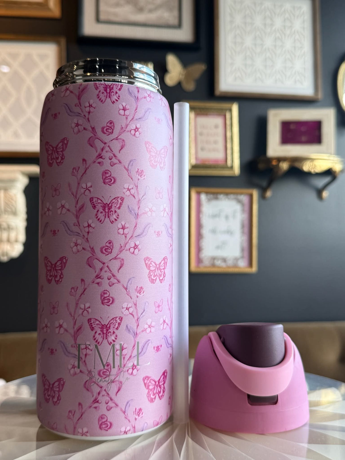 Pink butterfly-and-flower insulated bottle with black flip-top lid