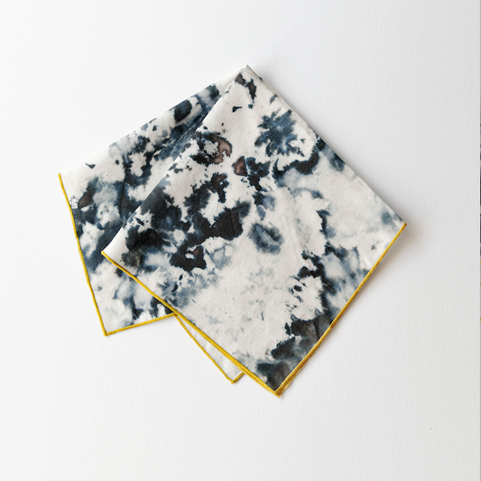Marble-print napkins with gold edging, white with dark blue-gray abstract pattern
