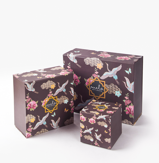 Set of 3 decorative gift boxes, dark brown with floral and crane pattern, “mela” logo