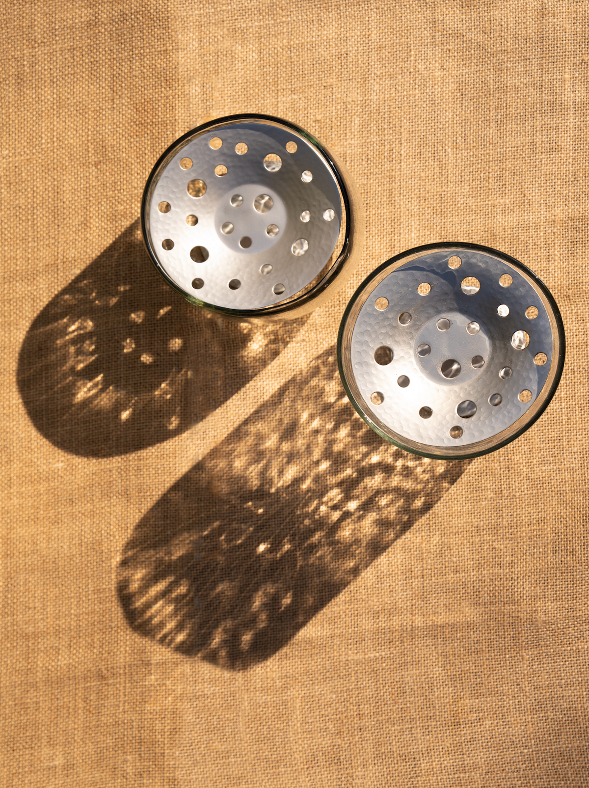 Round perforated metal flower frog inserts in brushed silver finish