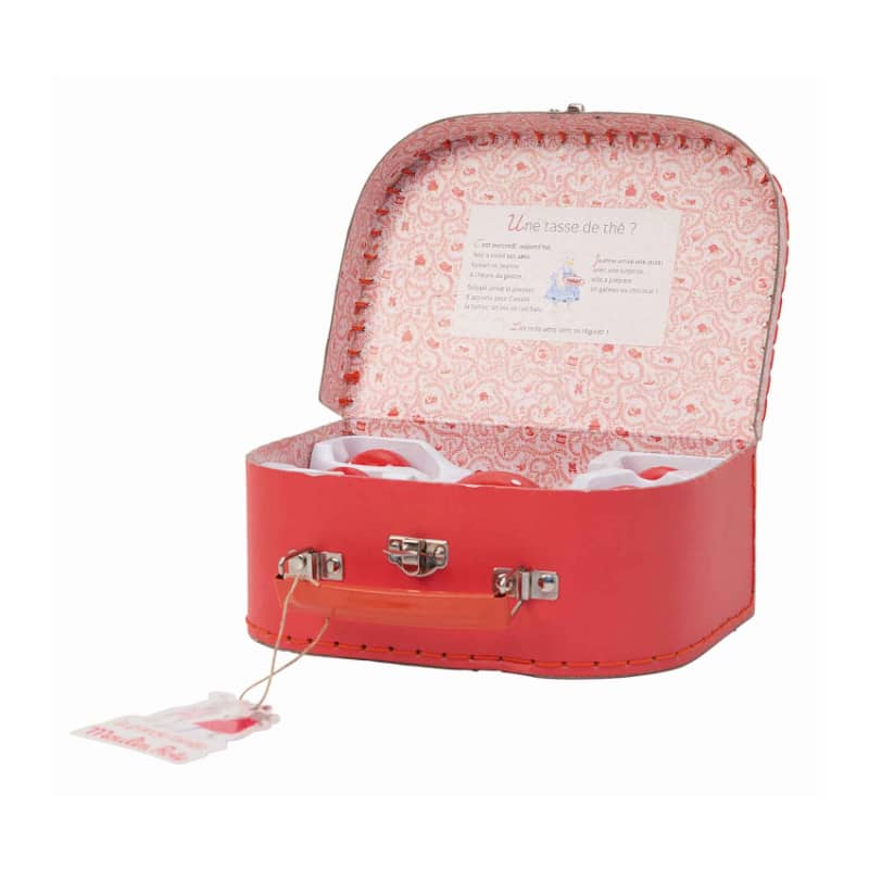 Open red tea set suitcase with patterned lining and ceramic pieces inside