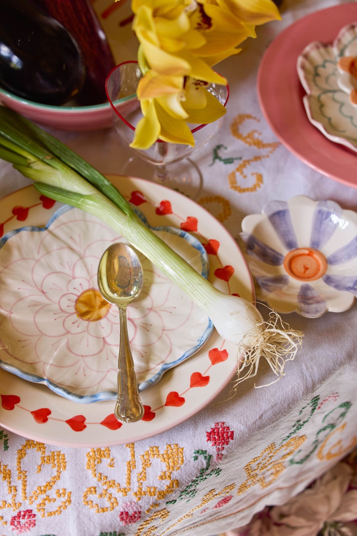 Flower-shaped ceramic side plate with blue edge, pink floral center and rim