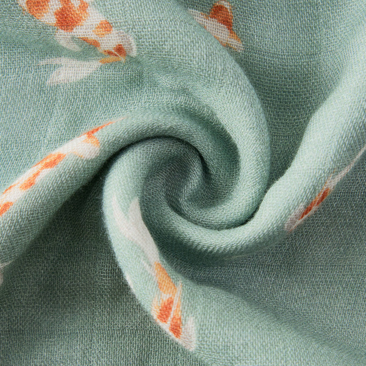 Textured teal muslin fabric with orange koi fish print