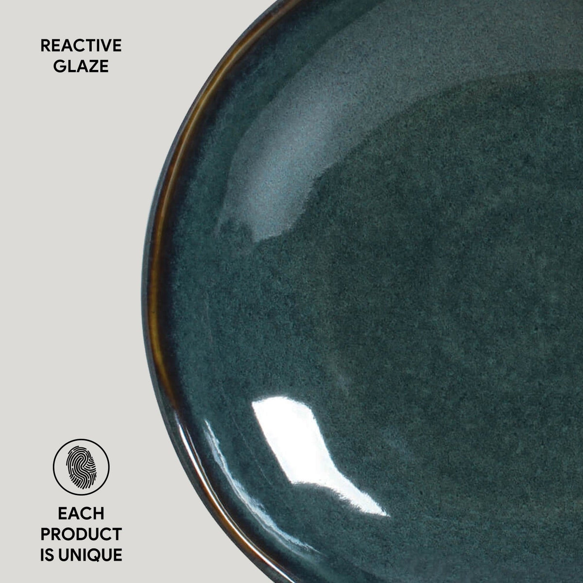 Teal reactive glazed pasta plate close-up, speckled texture and curved rim