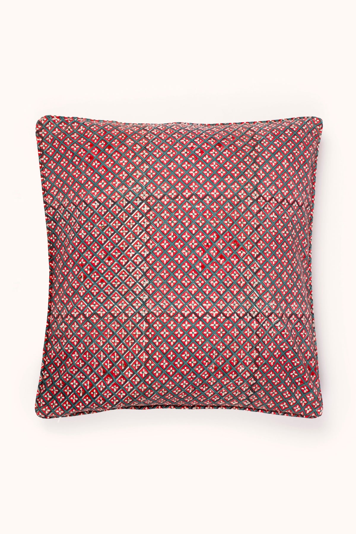 Crimson diamond-pattern square pillow cover with dark piping, neatly framed