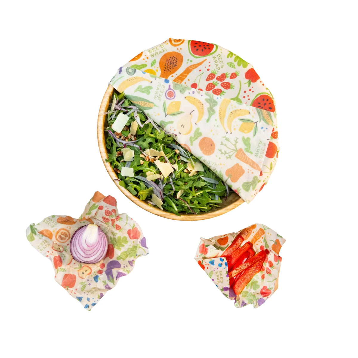 Reusable food wraps with colorful fruit-and-flower pattern in orange, cream, and green