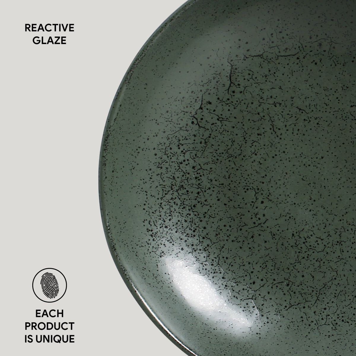 Reactive glazed pasta plate, close-up of speckled dark green ceramic glaze