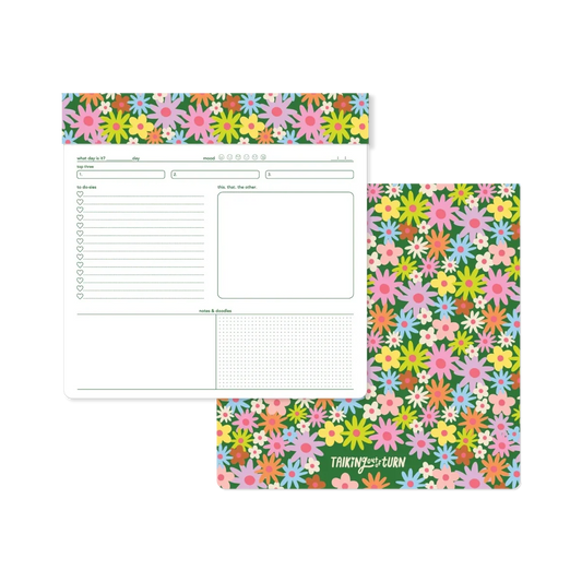 Floral notepad showing open ruled pages and matching flower-pattern cover