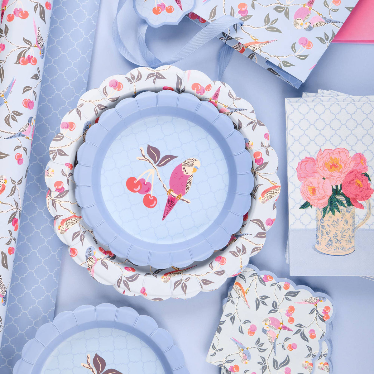 Scalloped blue dessert plates with bird and cherry pattern, plates stacked
