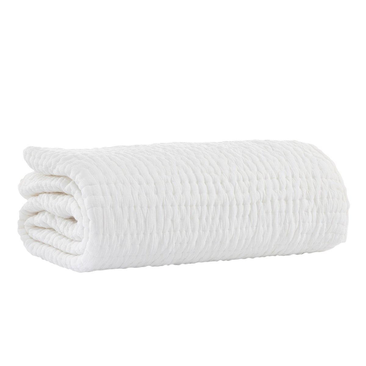 White quilt folded into a neat roll, featuring raised stitched texture