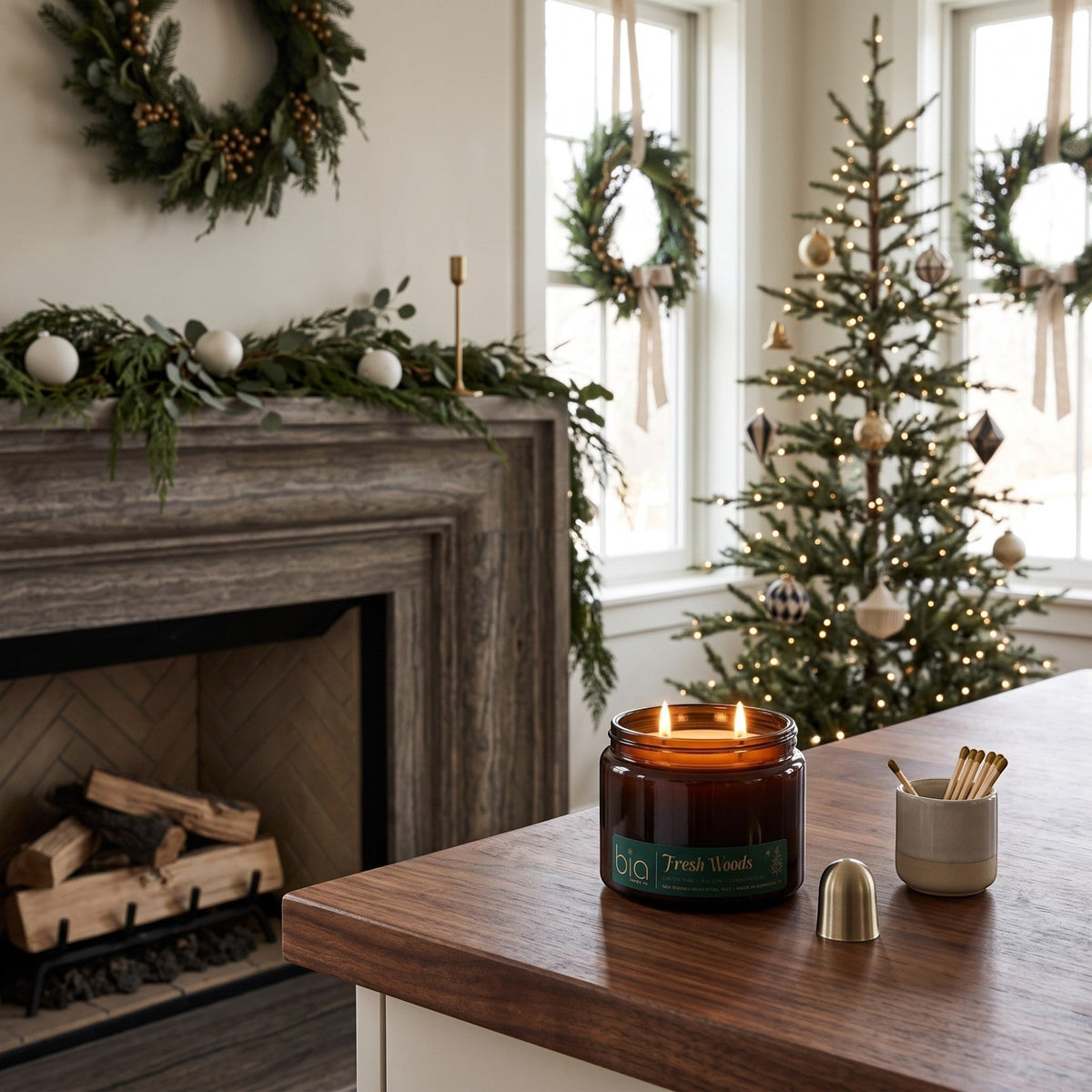 Amber glass candle jar with green label and lit flame on a wooden tabletop.