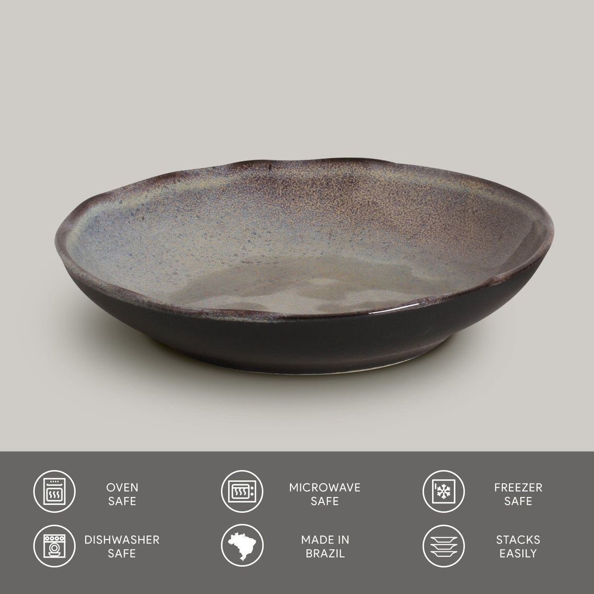 Dark reactive glaze pasta plate, round shallow bowl with speckled interior and rim.