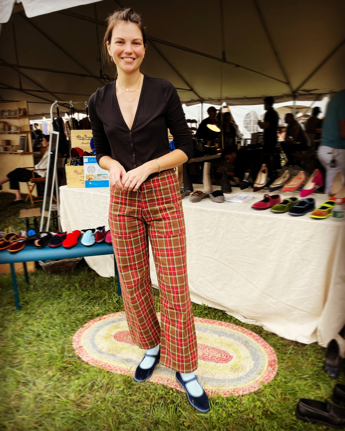 Camel suede Mary Jane flats with neon green trim, worn with plaid pants