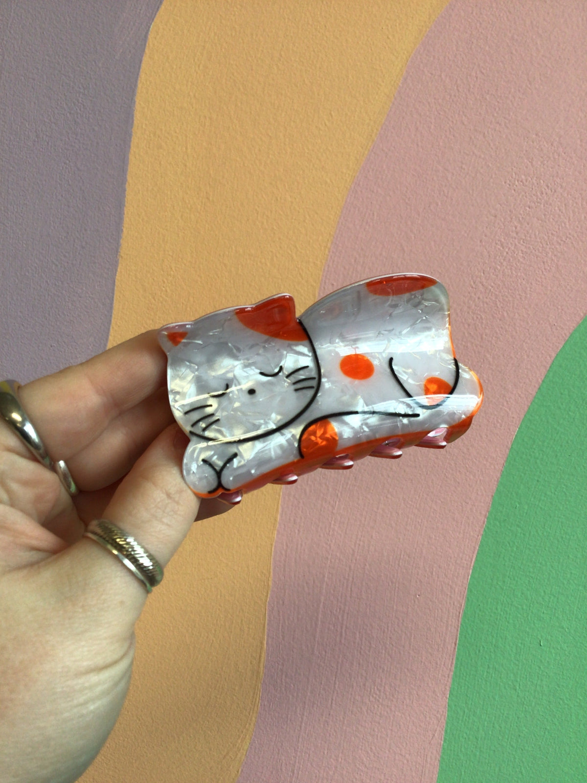 Clear cat hair claw with orange eye patch and black whisker lines
