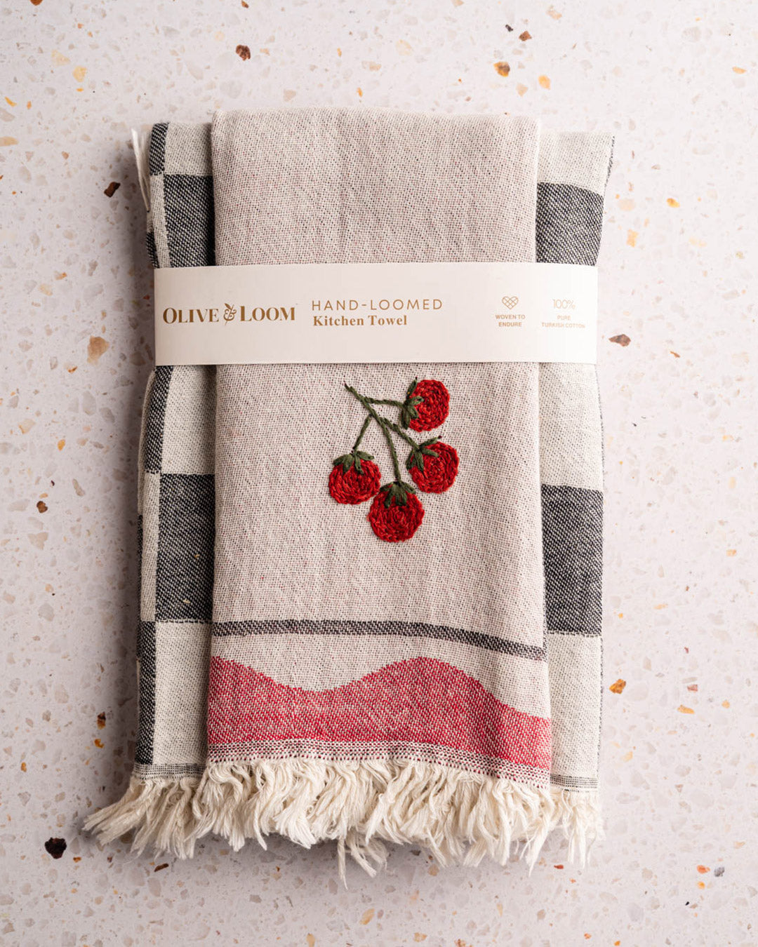 Kitchen towel set folded, beige with gray check trim, red tomato embroidery, fringed hem