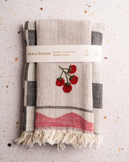 Kitchen towel set folded, beige with gray check trim, red tomato embroidery, fringed hem
