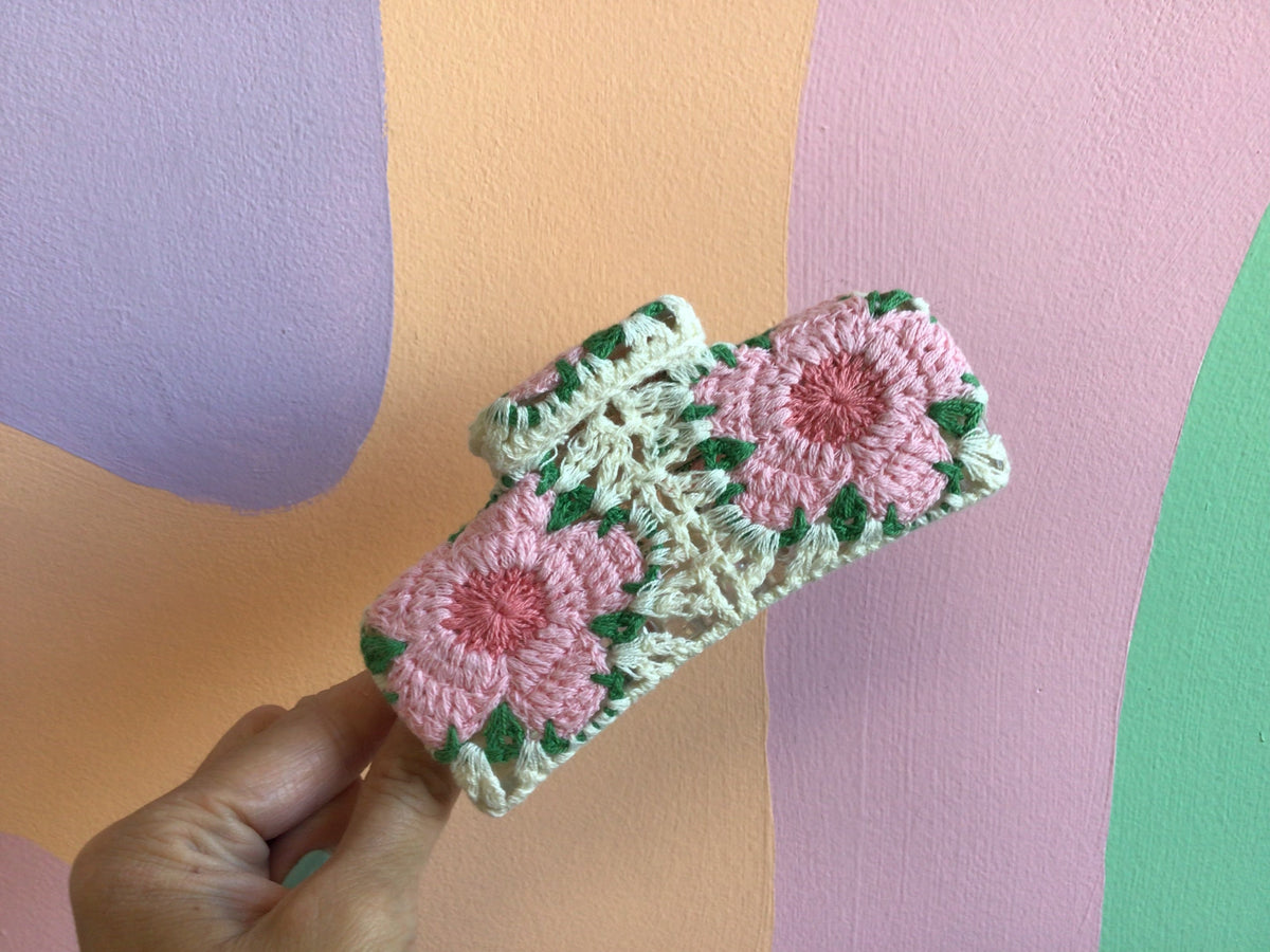 Crocheted hair claw with pink flower patches and mint green details